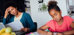 Student and parent doing homework. Both look unhappy